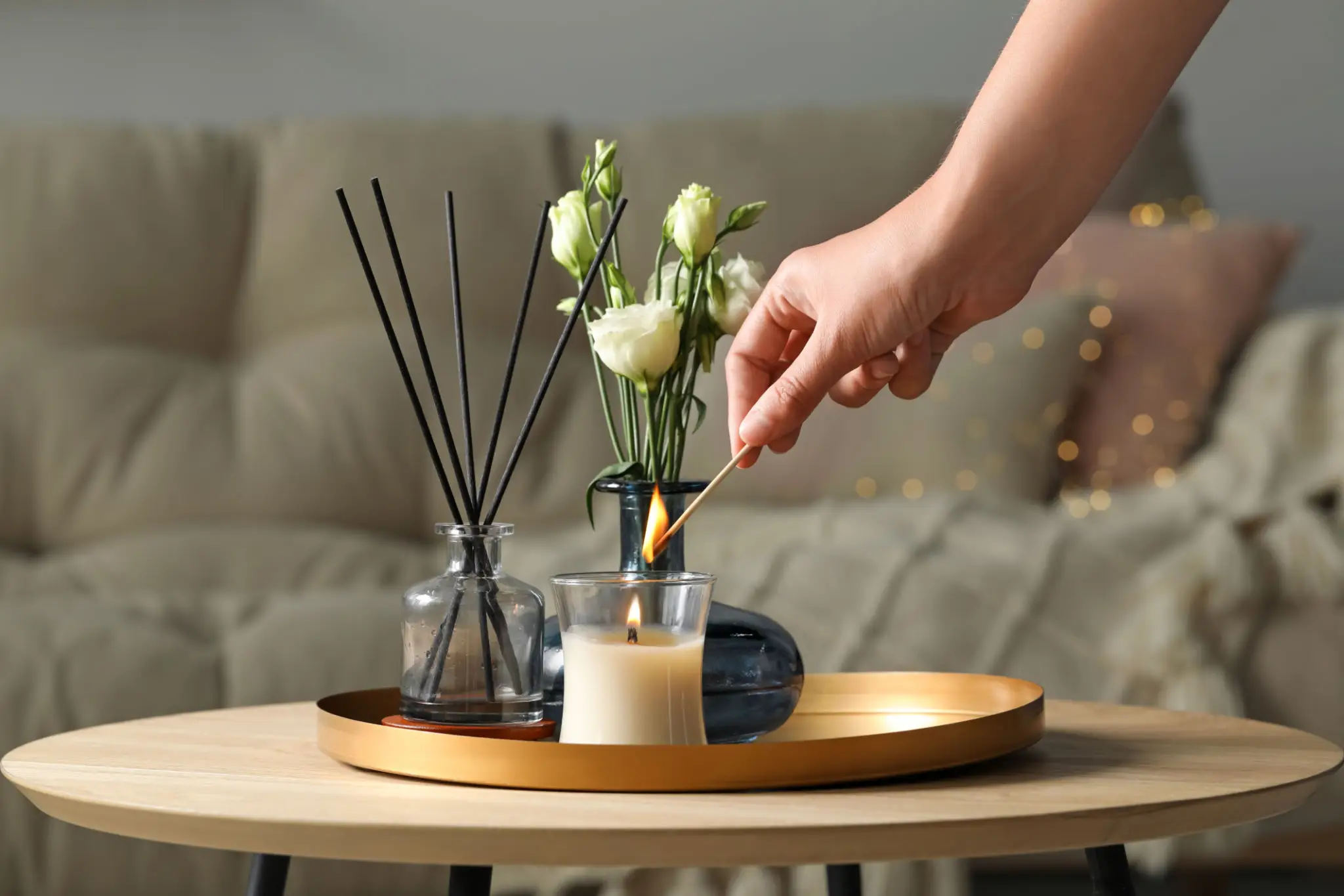 Lighting candle on decorative coffee table.