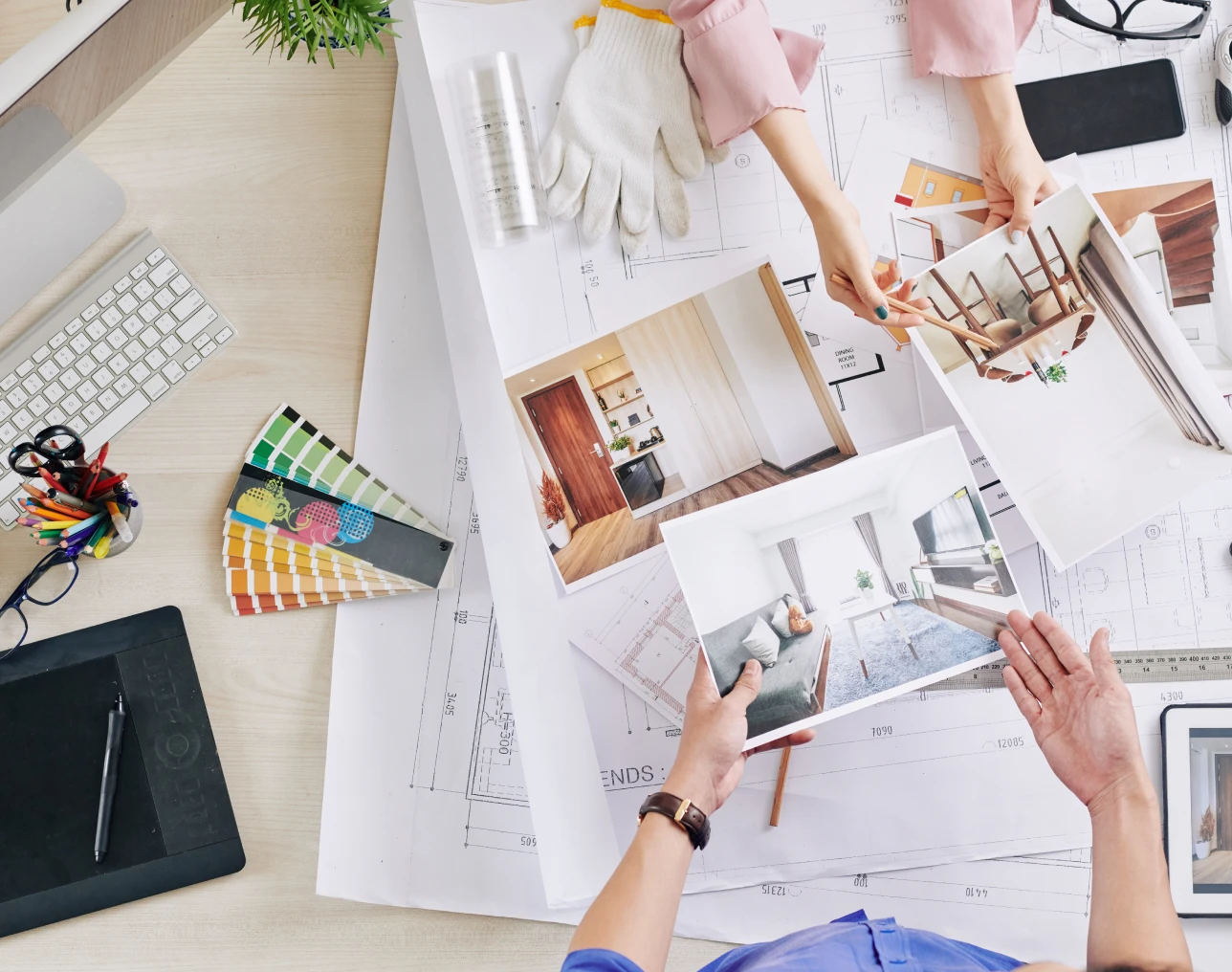 Interior design plans on a workspace table.