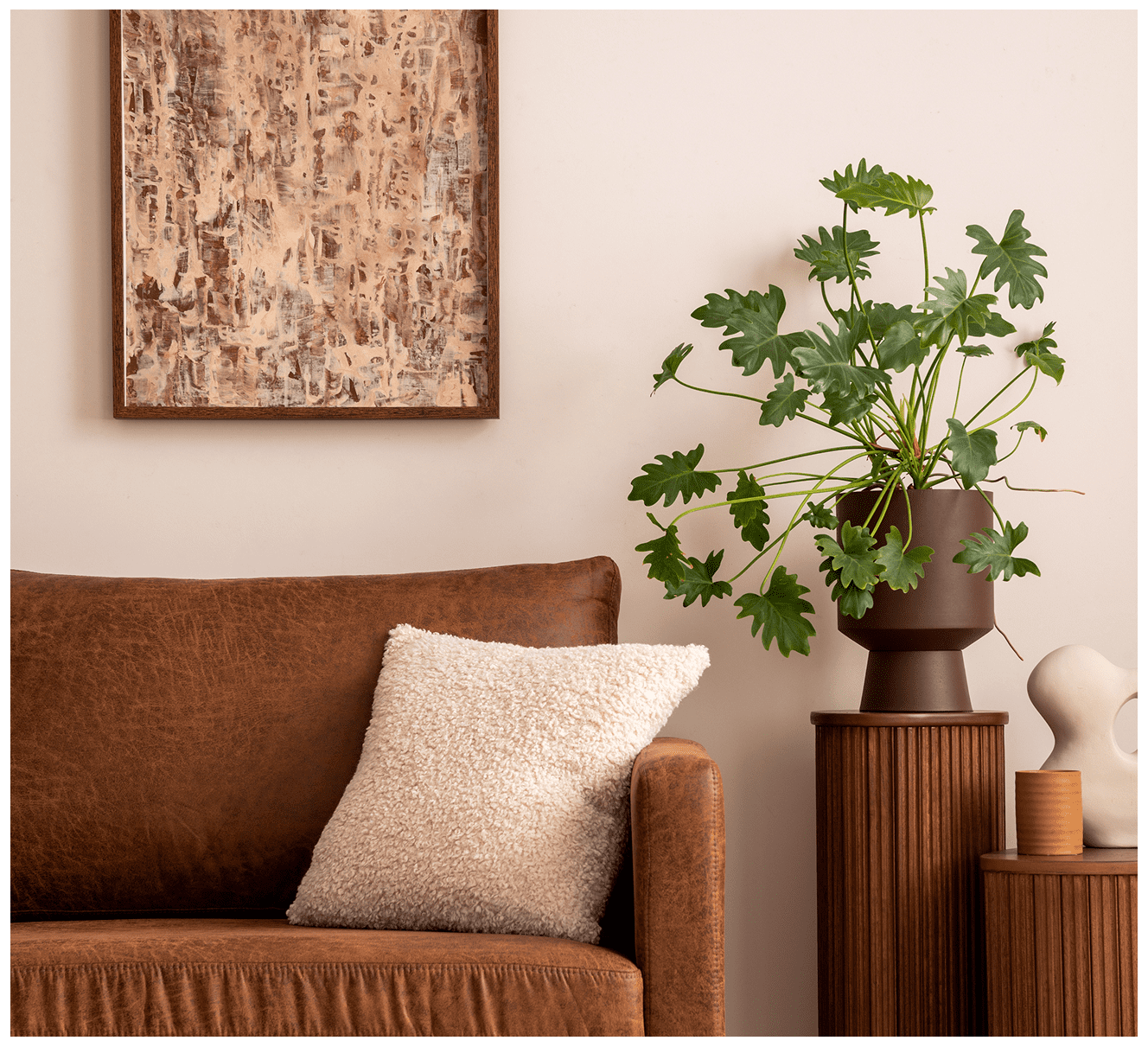 Cozy living room with plant and artwork.